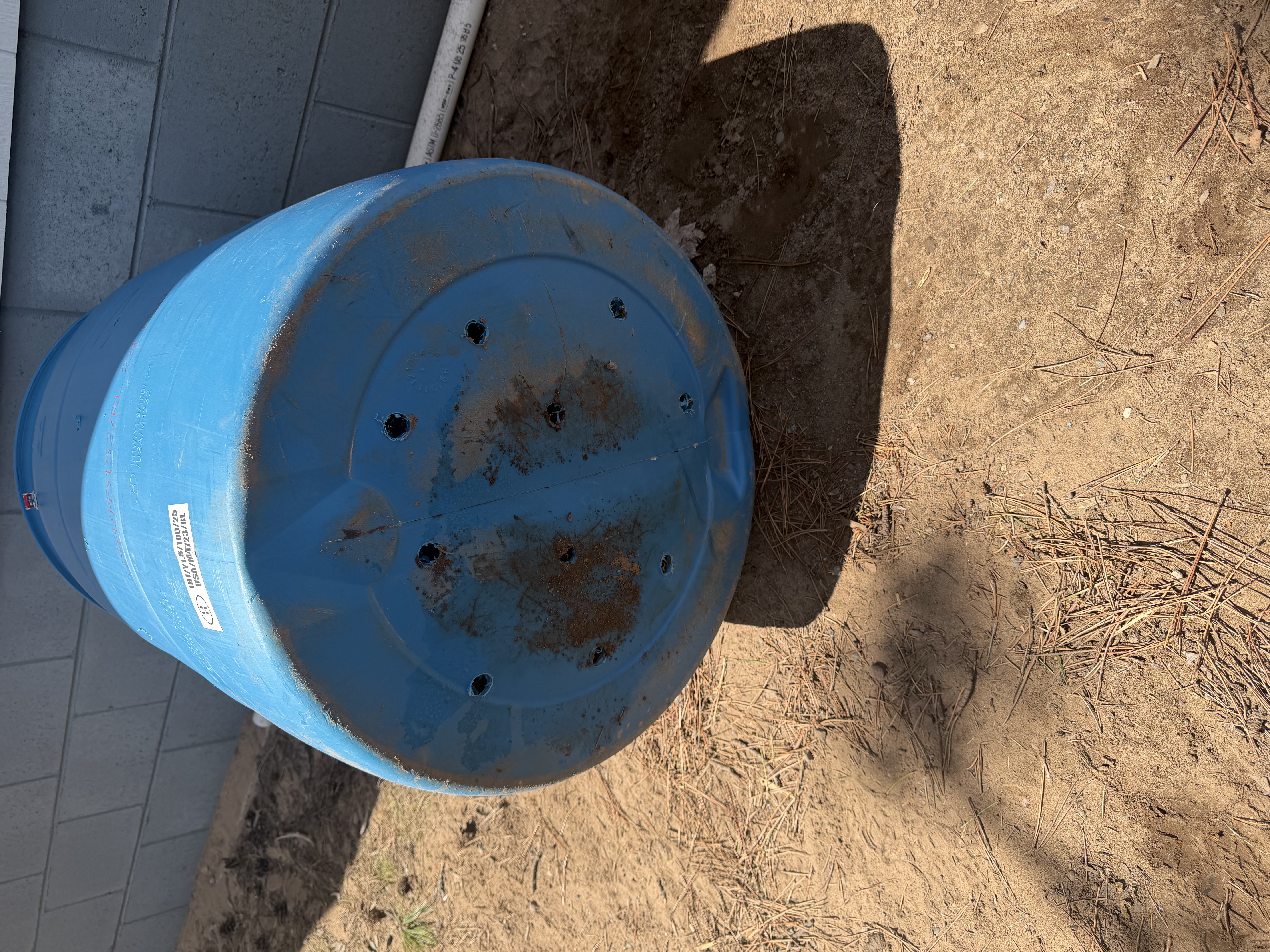 Drainage holes drilled in the bottom of the barrel