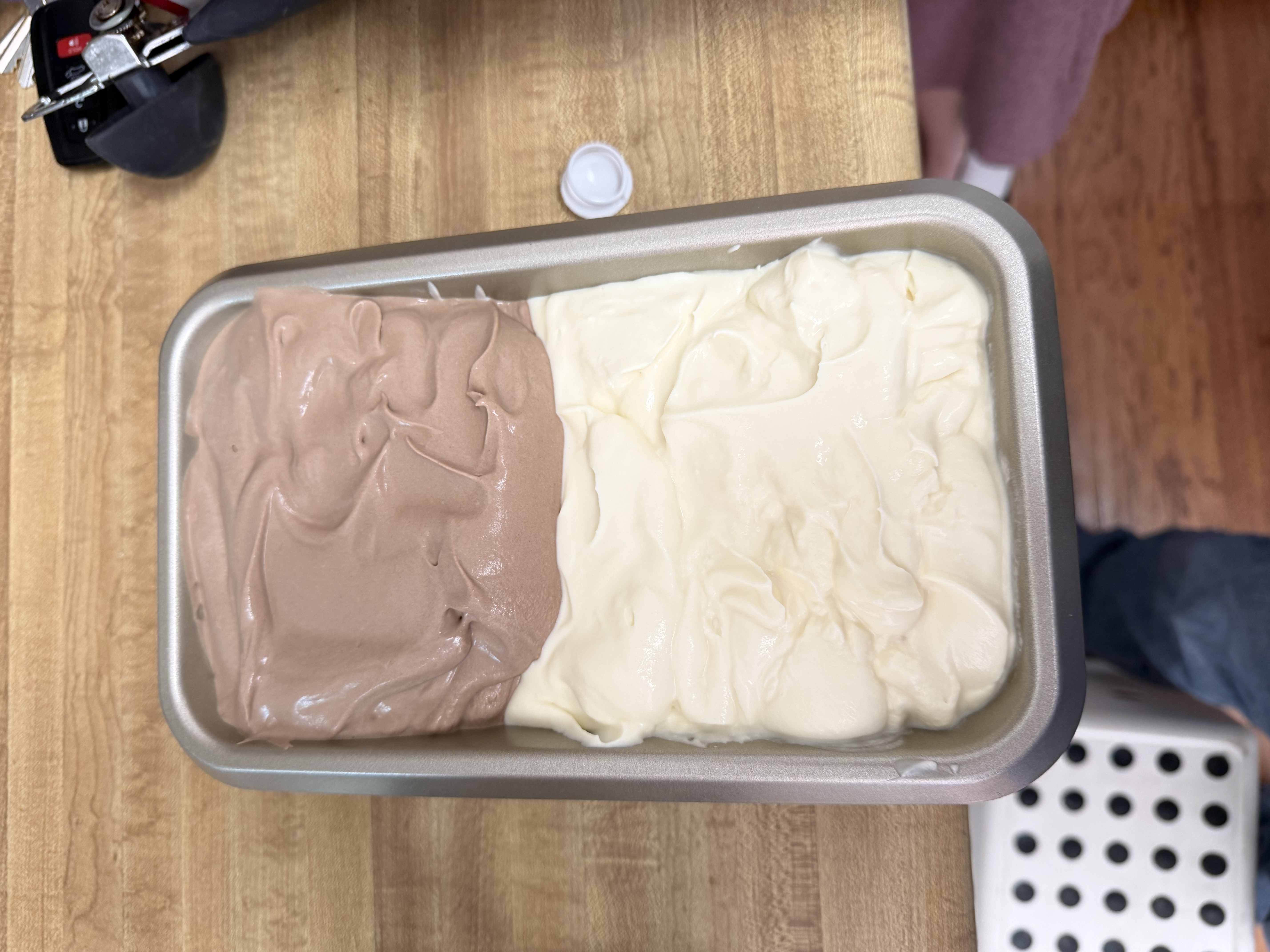 Vanilla and chocolate ice cream side by side in a loaf pan